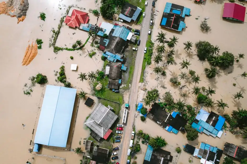 Drone view of a residential area in Kijal, Malaysia, showing extensive flooding and submerged buildings.
